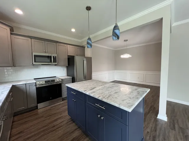 a kitchen with a stove a sink and a refrigerator