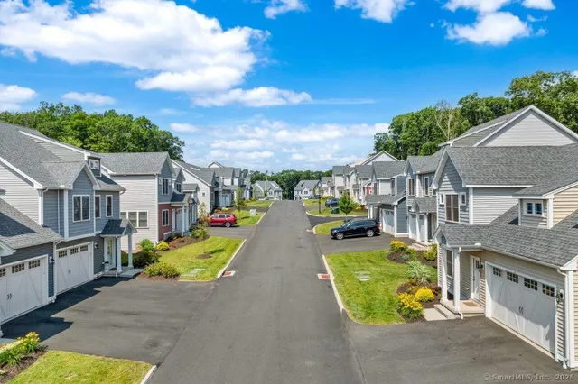 an aerial view of residential houses with outdoor space