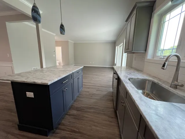 a kitchen with a sink stove and cabinets
