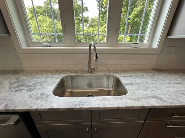 a kitchen with sink and window