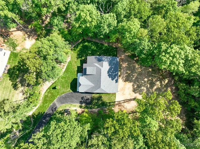 an aerial view of a house with a yard