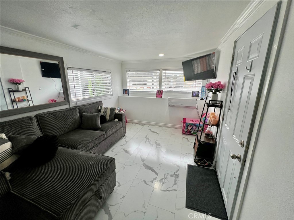 4849 Peck Road, Unit 48 El Monte, CA 91732 - Photo 3 of 11 a living room with furniture and a flat screen tv