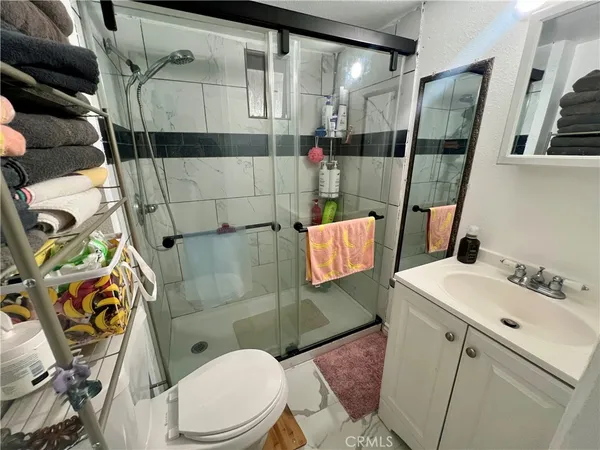 a bathroom with a sink toilet and shower