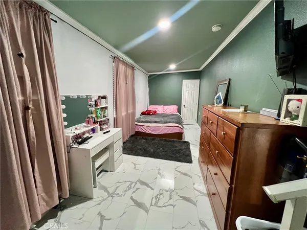 a bedroom with a bed and flat screen tv