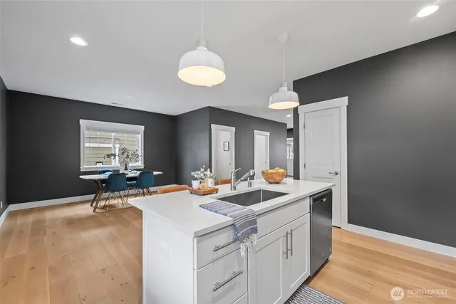 a kitchen with a sink and a stove top oven