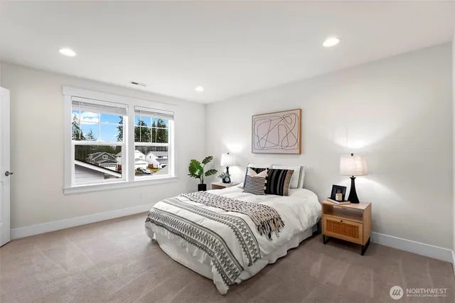 a spacious bedroom with a bed and window