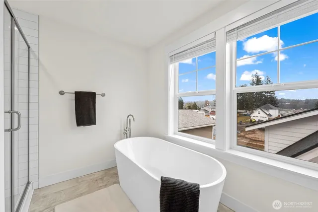 a white bath tub sitting next to a window