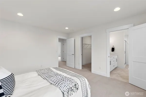 a bedroom with a bed and cabinets