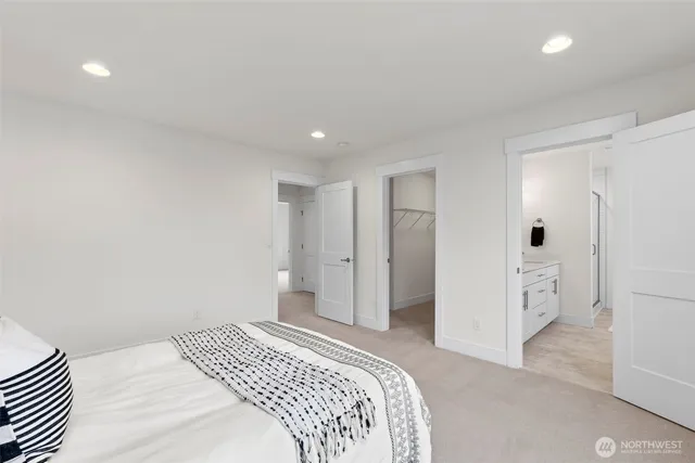 a bedroom with a bed and cabinets