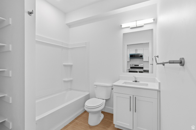 2085 North Main Street, Unit 409 Sunset, UT 84015 - Photo 8 of 17 Full bathroom featuring vanity, light wood finished floors, and bathtub / shower combination