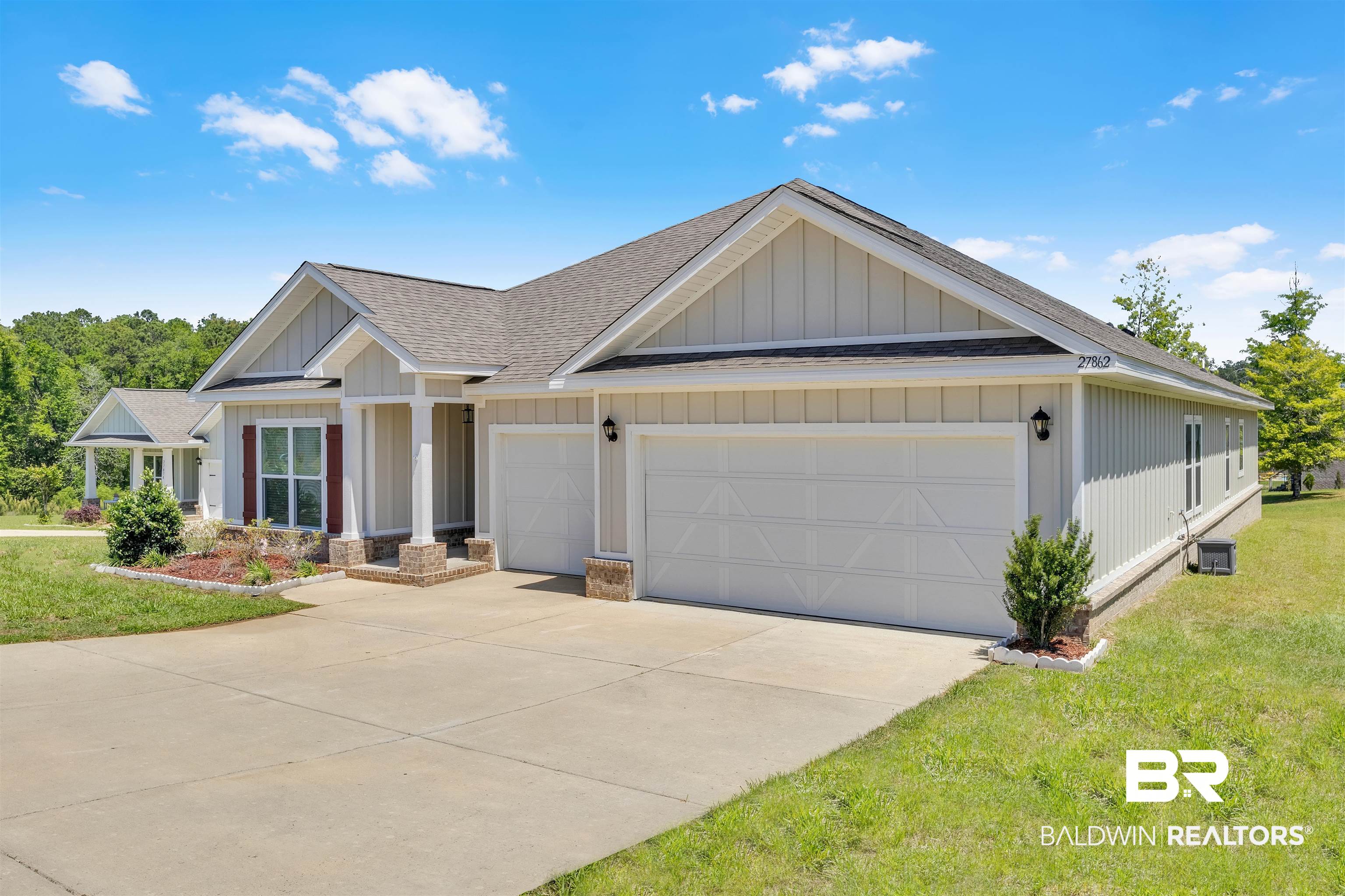 27862 Jade Court Daphne, AL 36526 - Photo 4 of 33 View of front of home with board and batten siding, a front lawn, roof with shingles, and a garage