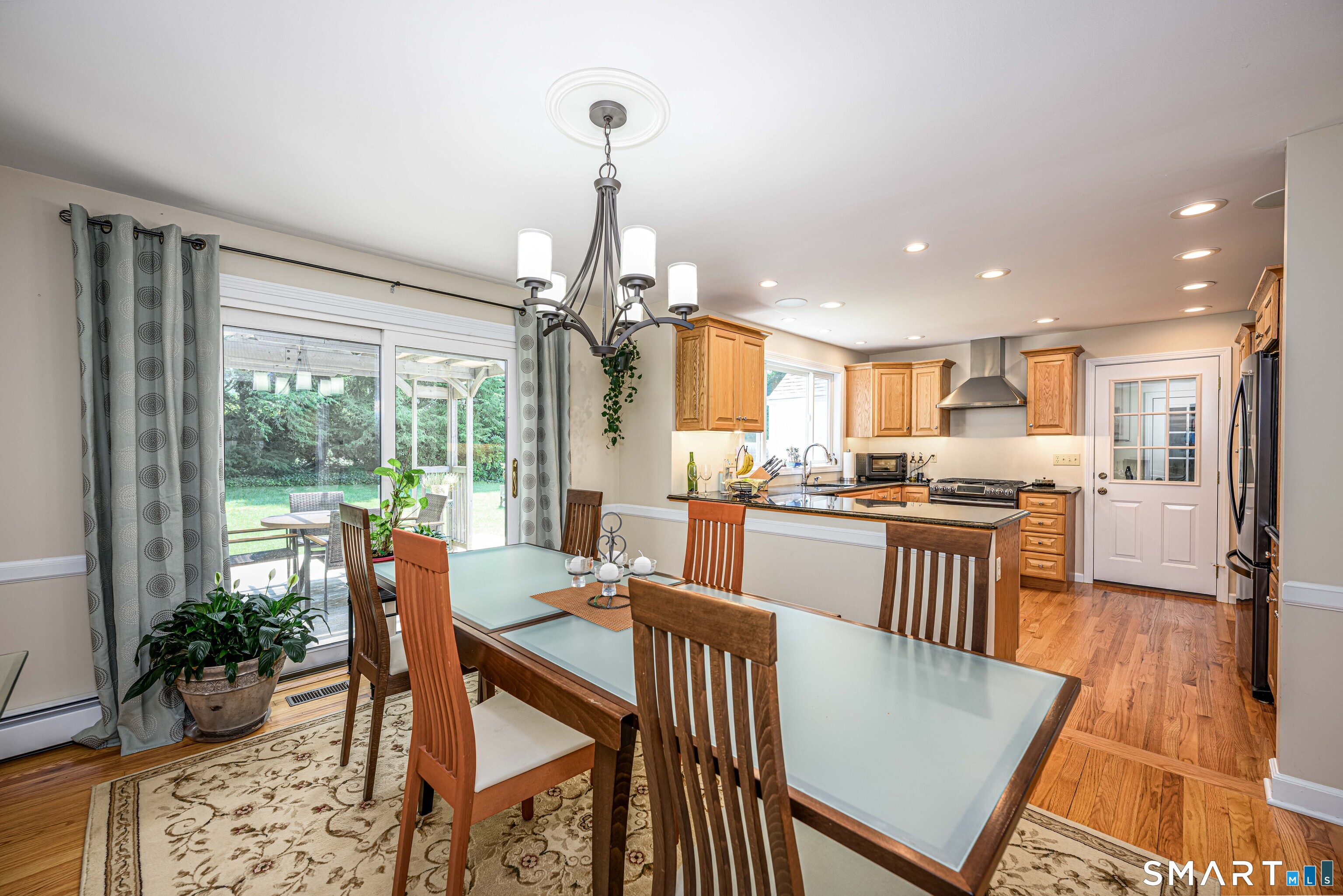25 Wright Lane Hamden, CT 06517 - Photo 13 of 38 View of dining area with slider to deck looking into the remodeled kitchen.