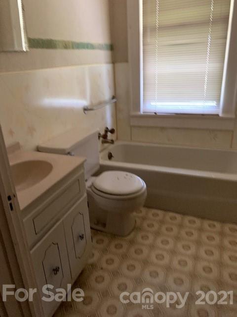 4613-4617 Fallston Road Fallston, NC 28090 - Photo 15 of 21 a bathroom with a granite countertop toilet and a sink