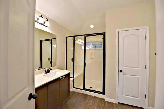 a bathroom with double vanity sink and mirror
