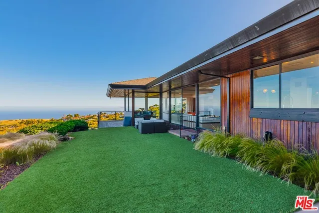 a view of a patio with furniture and garden