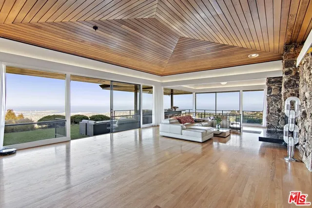 a outdoor space with lots of furniture and view of living room