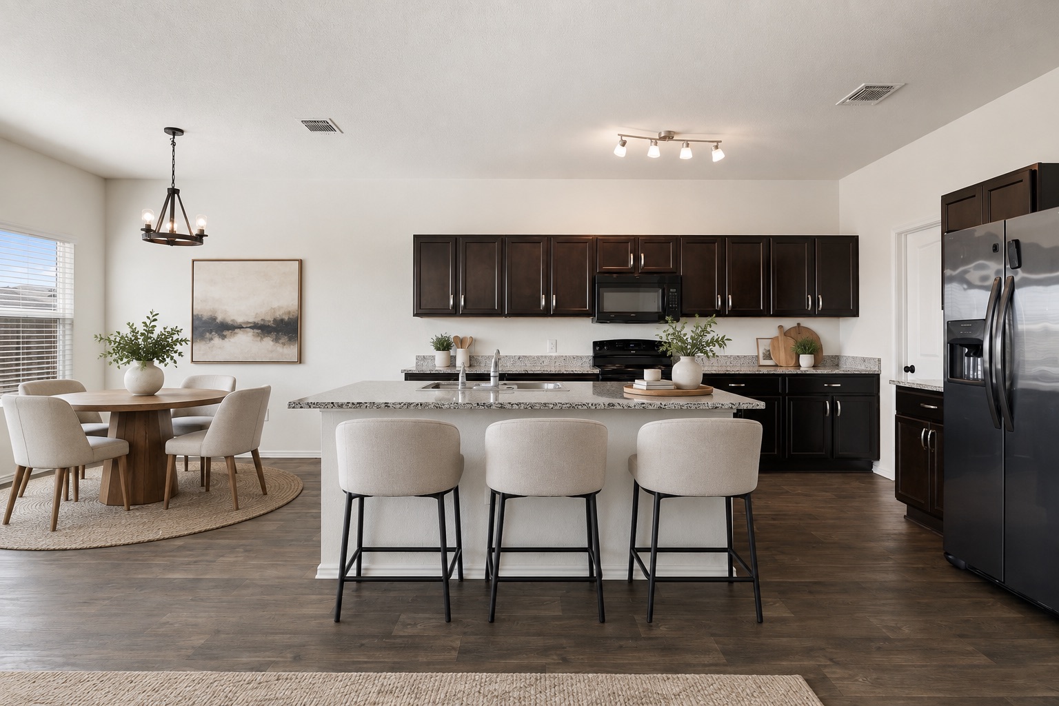 15011 Tuff Rd Manor Manor, TX 78653 - Photo 3 of 37 Virtually staged kitchen with a large granite island, breakfast bar seating, espresso cabinets, black appliances, and an adjacent dining nook with a modern pendant light.