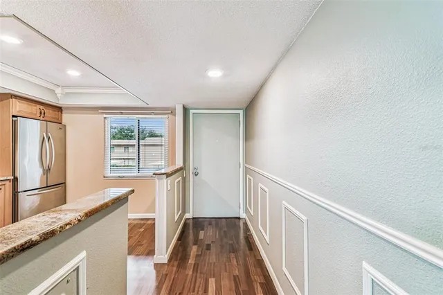 a view of a room with wooden floor fan and windows