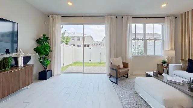 a living room with furniture and a large window