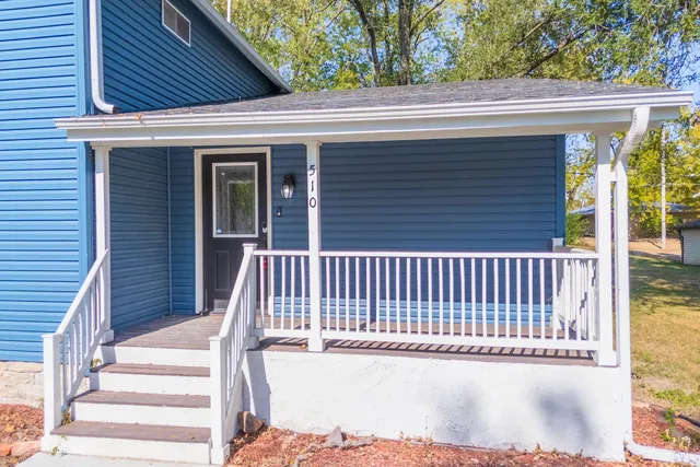 a view of a wooden house and a yard