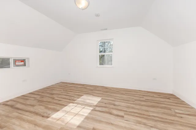 a view of a room with wooden floor and white walls