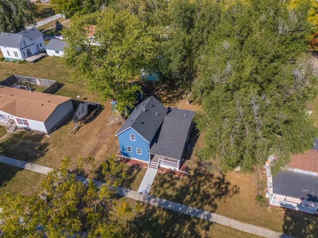 an aerial view of a house with outdoor space and street view