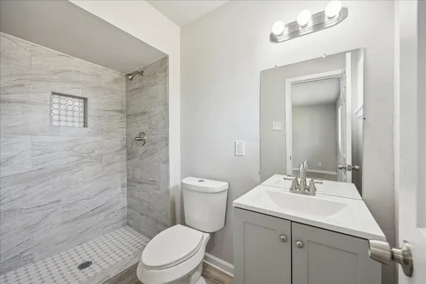a bathroom with a sink toilet and shower