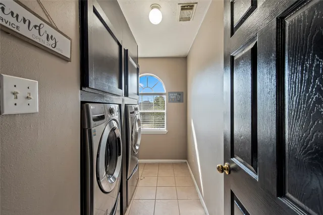 a view of a hallway with washer and dryer