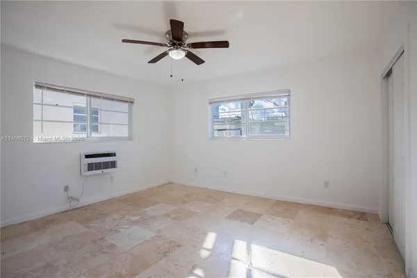 a view of a livingroom with a ceiling fan and window