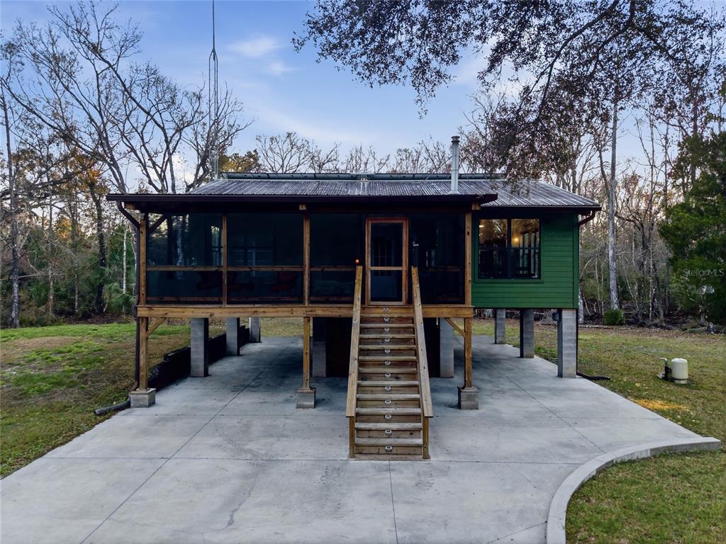 0 Clayton Road Cedar Key, FL 32625 - Photo 2 of 22 a view of a house with a yard and a large tree