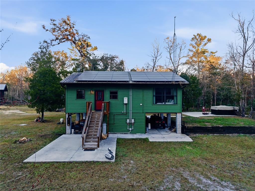 0 Clayton Road Cedar Key, FL 32625 - Photo 3 of 22 a front view of a house with garden and trees