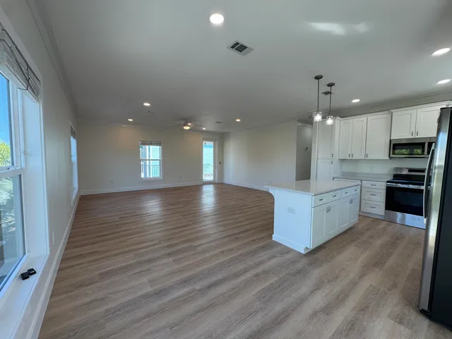 a view of kitchen with cabinets and wooden floor