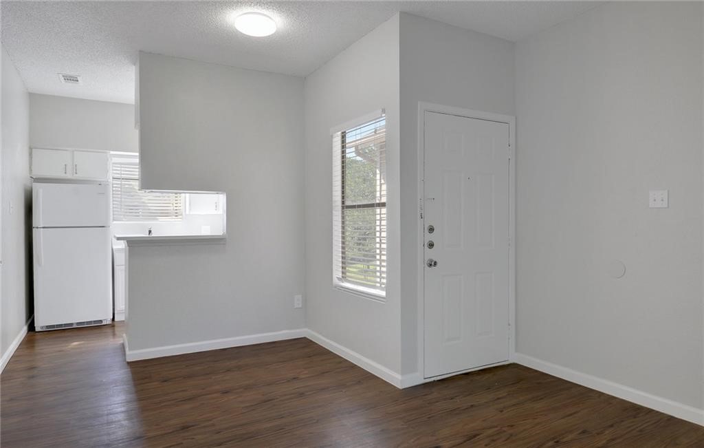 9509 Kempler Drive Austin, TX 78748 - Photo 3 of 12 an empty room with wooden floor and windows