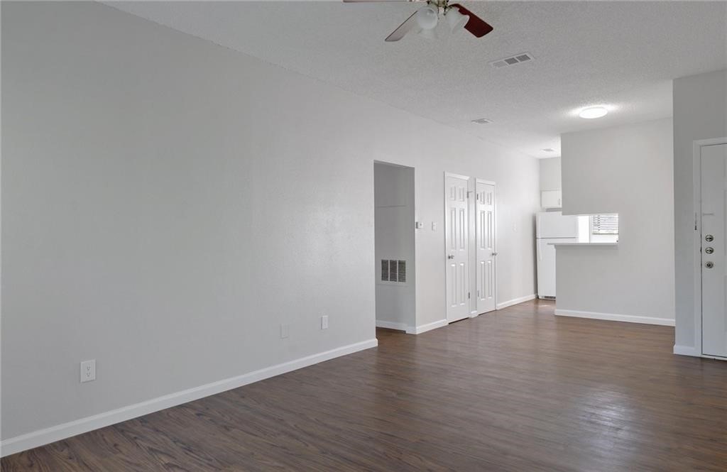 9509 Kempler Drive Austin, TX 78748 - Photo 4 of 12 a view of an empty room with wooden floor