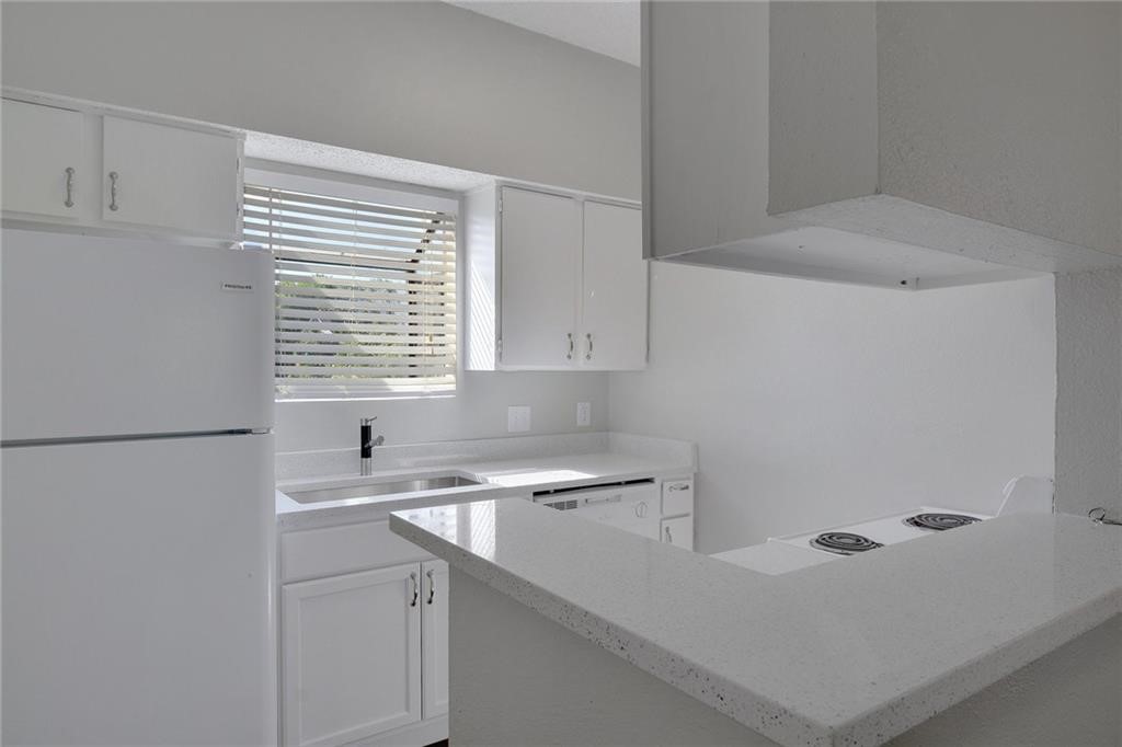 9509 Kempler Drive Austin, TX 78748 - Photo 6 of 12 a kitchen with a sink cabinets and a refrigerator