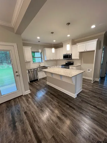 a view of living room with granite countertop furniture and wooden floor