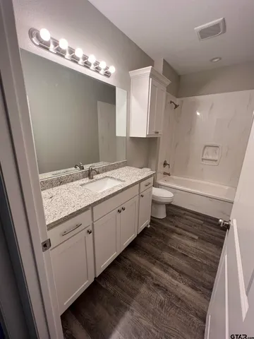 a view of a ground with large trees