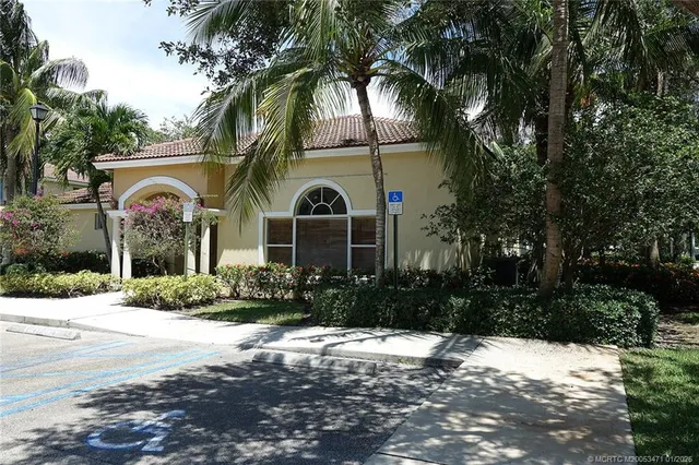a view of a hallway with wooden floor and cabinet