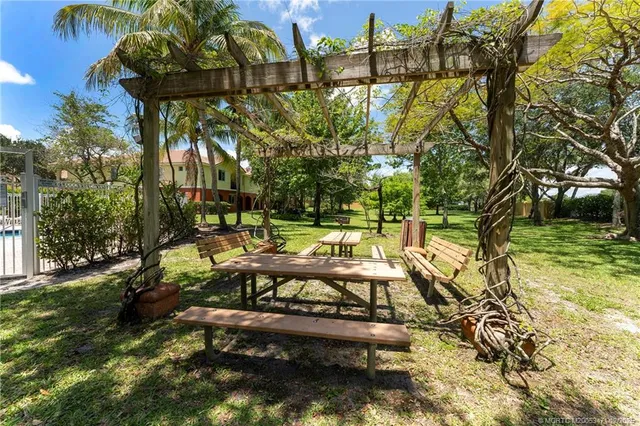 a view of yard with swimming pool and sitting area