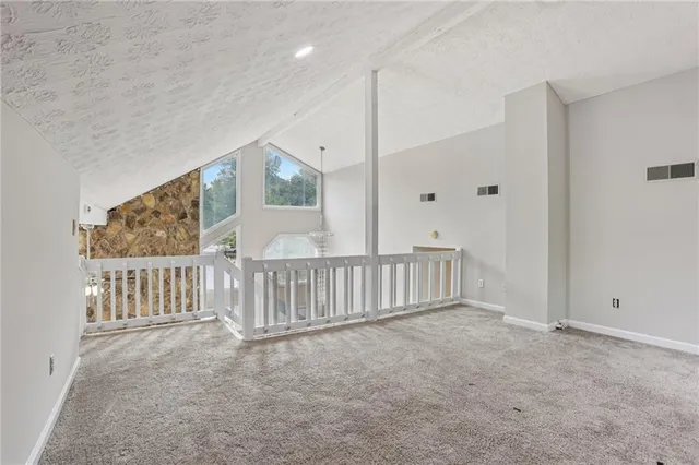 a view of an empty room with windows