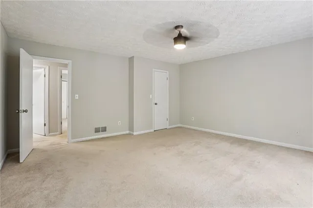 an empty room with a empty space and a ceiling fan