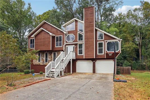 a front view of a house with a yard and garage