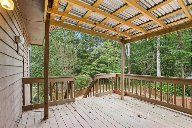 a porch with wooden floor in front of a house