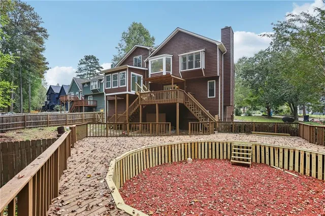 a view of a house with a wooden deck