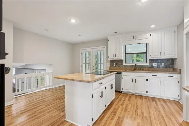 a large white kitchen with cabinets