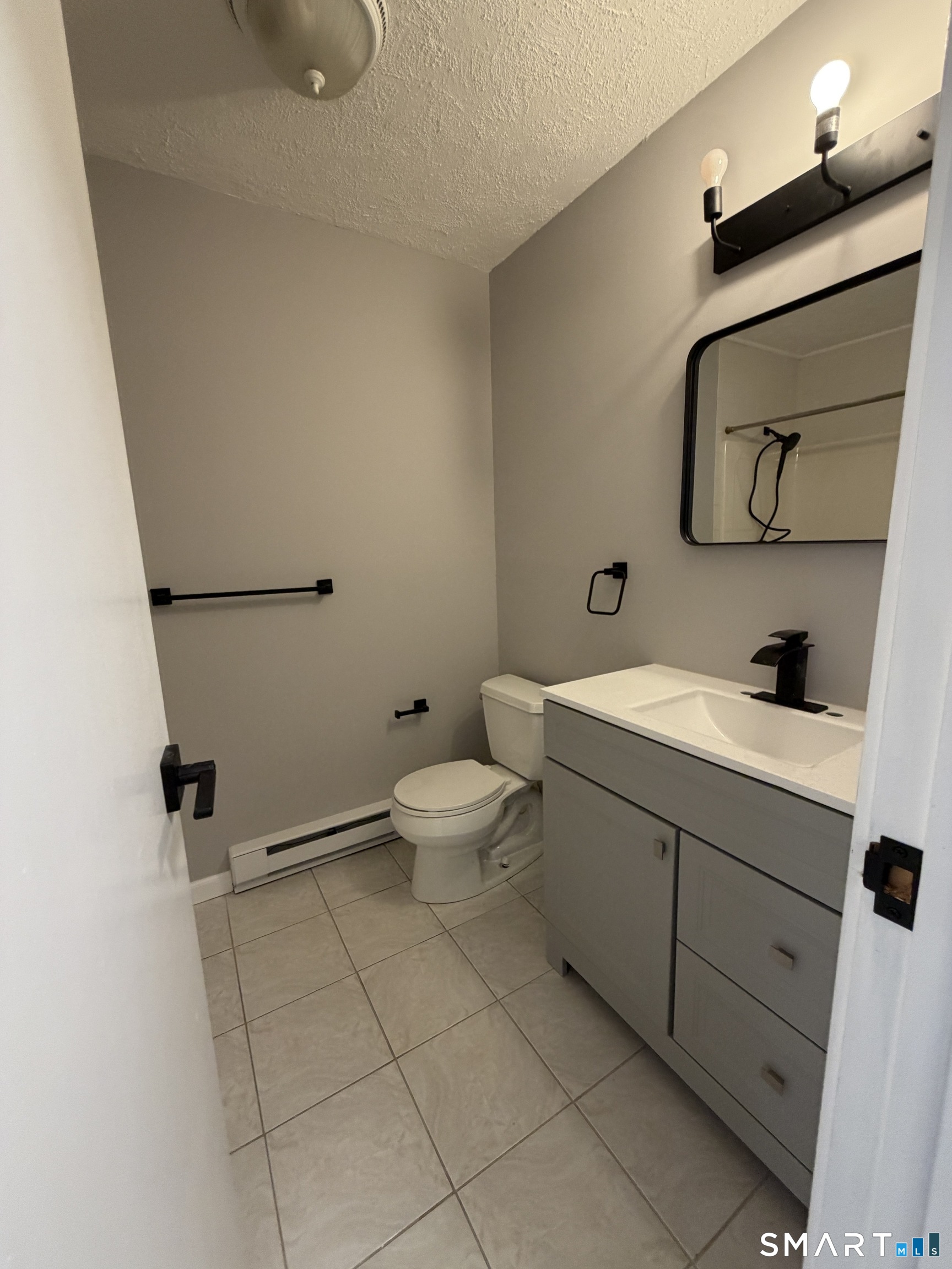 131 Pocono Road Brookfield, CT 06804 - Photo 21 of 27 a bathroom with a toilet sink and mirror