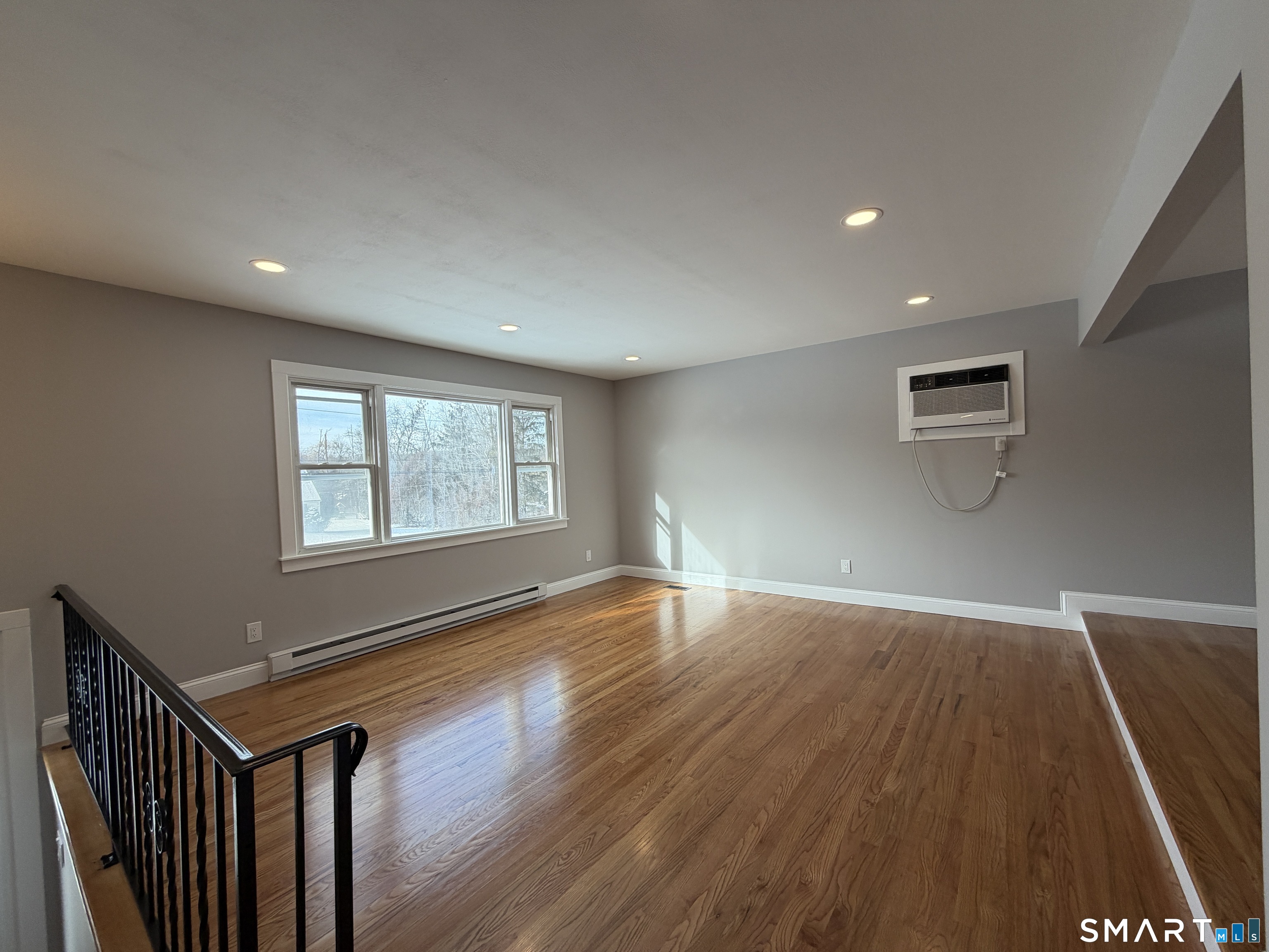 131 Pocono Road Brookfield, CT 06804 - Photo 3 of 27 a view of an empty room with wooden floor and a window