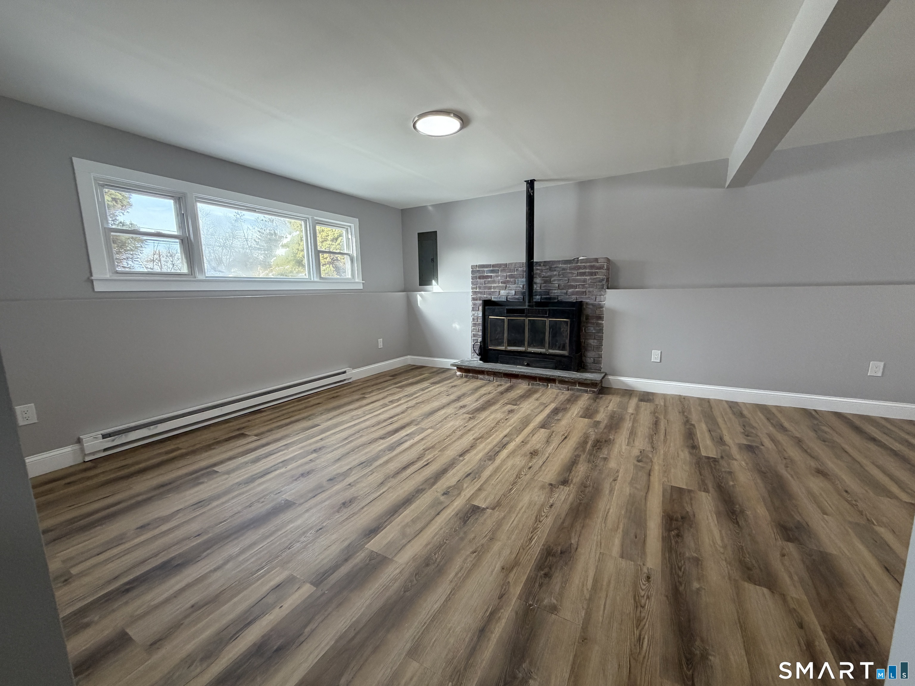 131 Pocono Road Brookfield, CT 06804 - Photo 6 of 27 a view of empty room with a fireplace and wooden floor