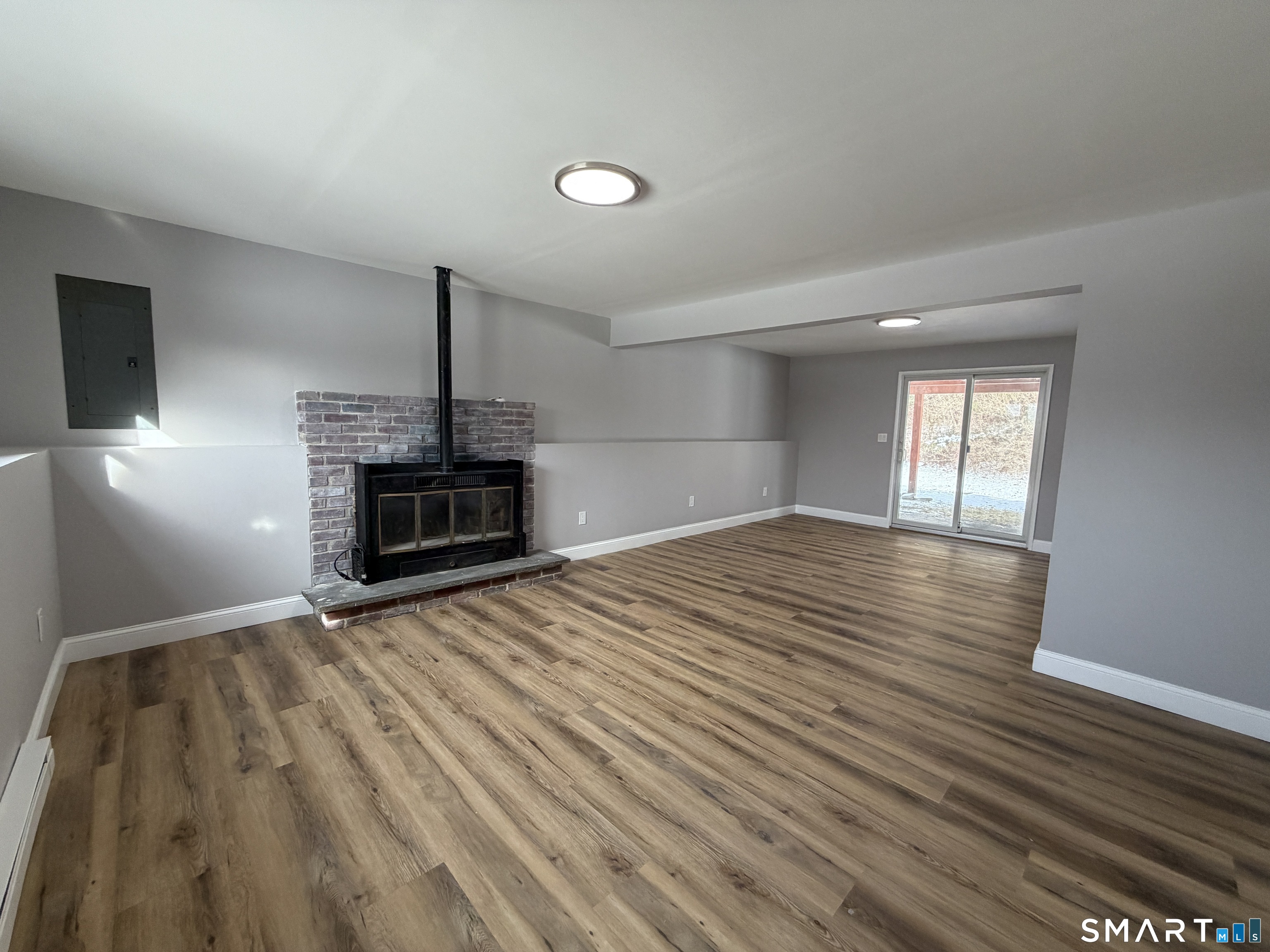 131 Pocono Road Brookfield, CT 06804 - Photo 7 of 27 an empty room with wooden floor fireplace and windows