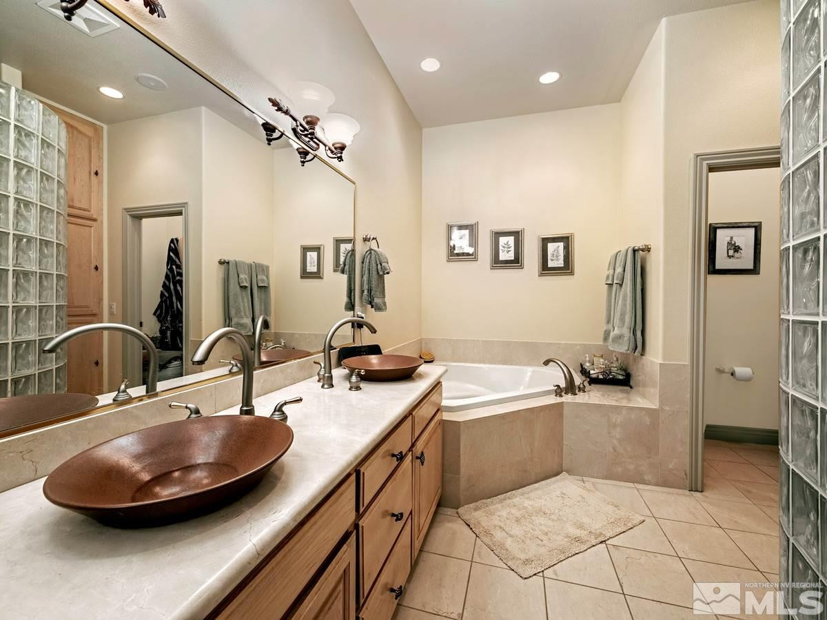 39 Sawbuck Road Reno, NV 89519 - Photo 11 of 23 a bathroom with a tub sink and mirror